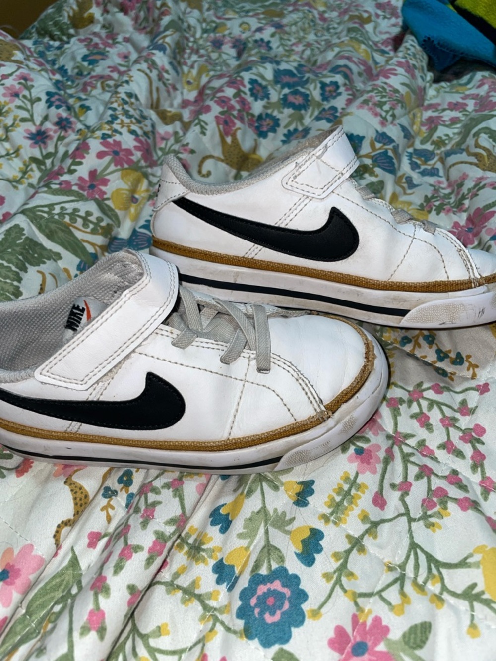 Nike Kids White Sneakers with Black Swoosh and Gold Trim